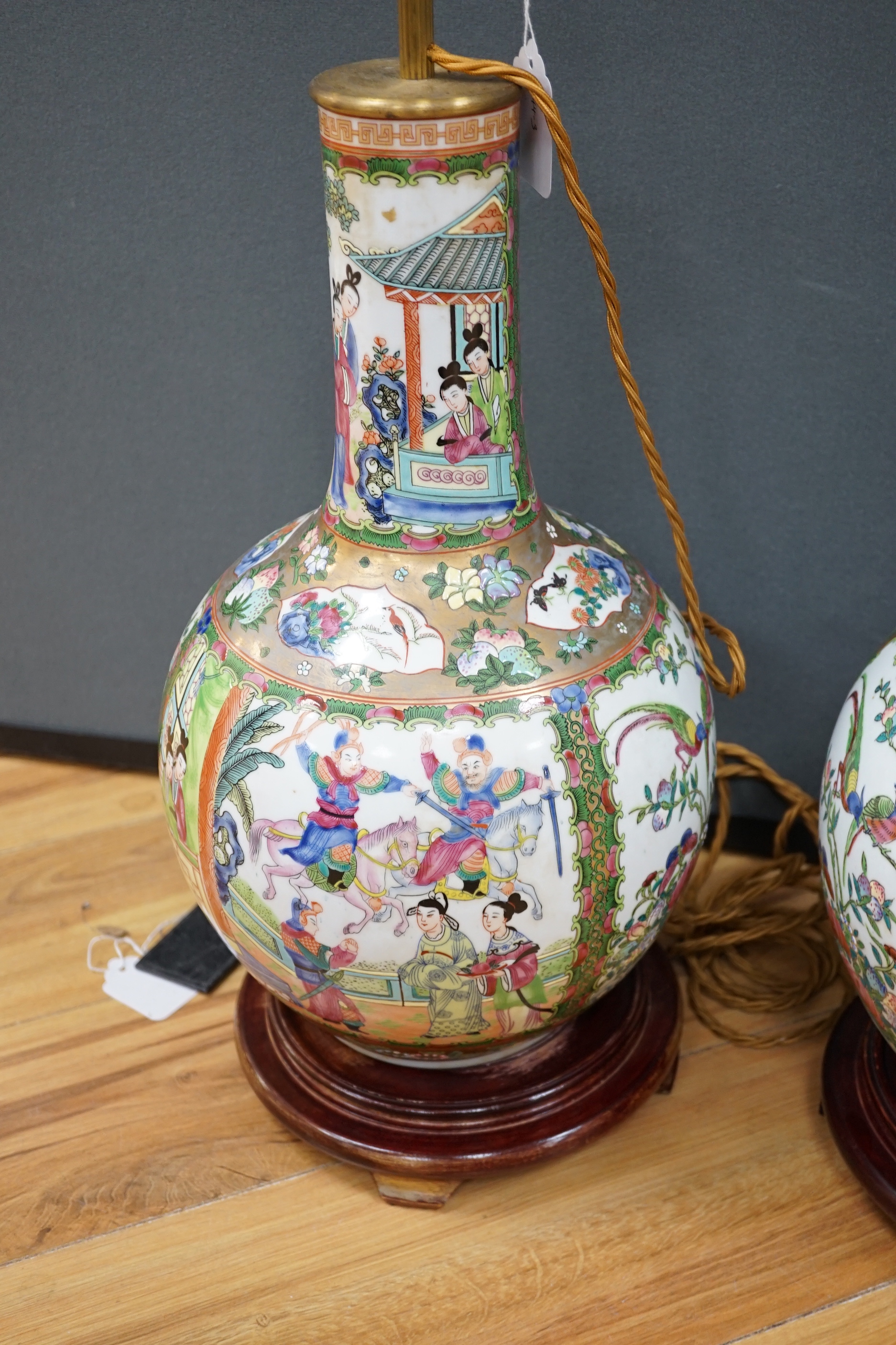 A pair of Chinese famille rose lamp bases on wooden stands, 50cm high